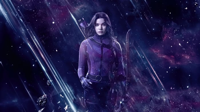 Kate Bishop in a purple suit with a bow and arrow