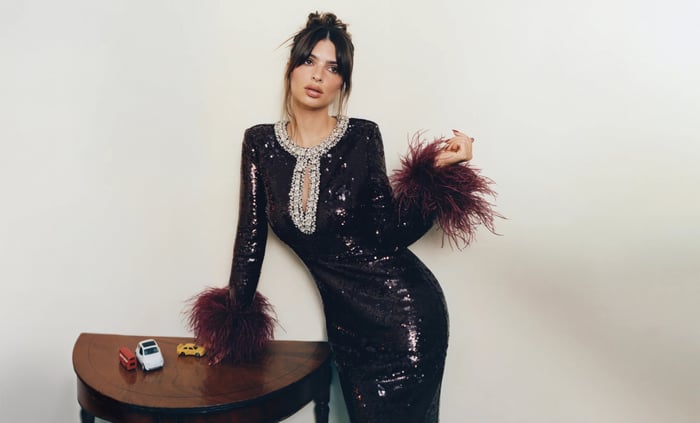 Emily Ratajkowski in a sequined dress with feather cuffs