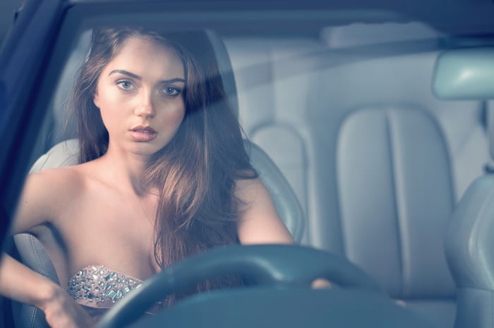 Woman in a car wearing a jeweled top
