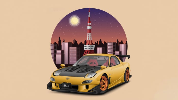 Yellow Mazda RX-7 with Tokyo Tower in the background