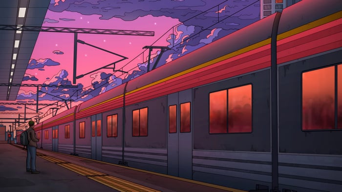 Man on train platform at sunset