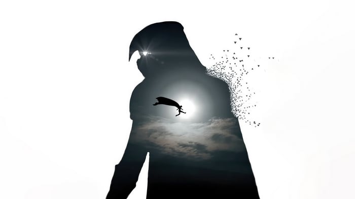 Moon Knight silhouette with a figure running towards the sun