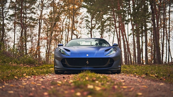 Blue 2023 Ferrari 812 GTS in a forest