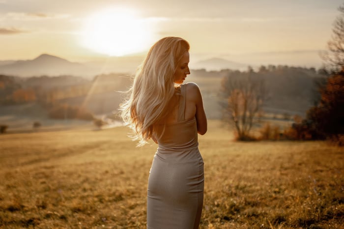 Blonde woman in a dress at sunset