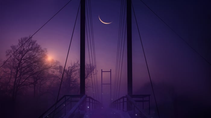 Bridge at twilight with a crescent moon