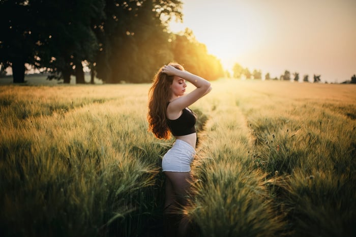 Girl in a field at sunset
