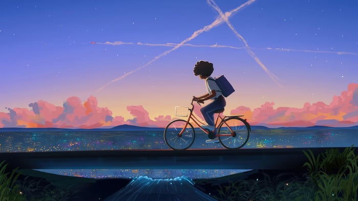 Girl cycling on a bridge at sunset over a city