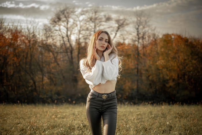 Woman in white top and leather pants outdoors