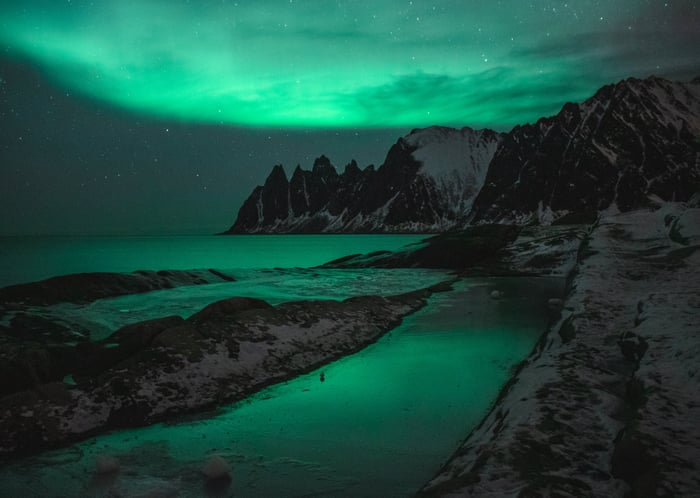 Rocky Mountains and Aurora Lights over the Ocean