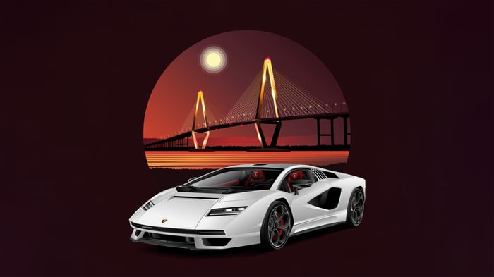 White Lamborghini Countach in front of a bridge at sunset