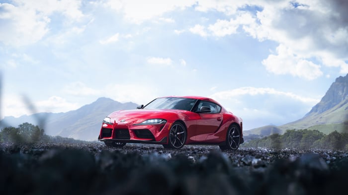 Red Toyota Supra on a rocky mountain road