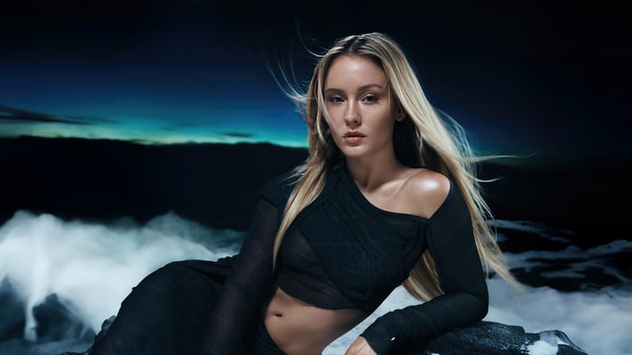 Zara Larsson in a black outfit with windblown hair