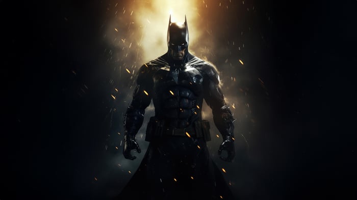 Batman stands in front of a bright light with sparks