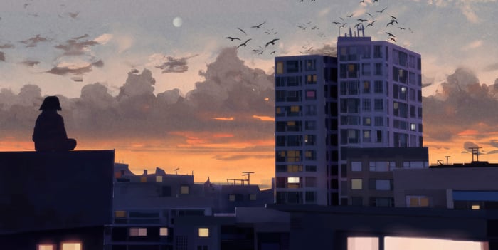 Person sitting on a rooftop at sunrise