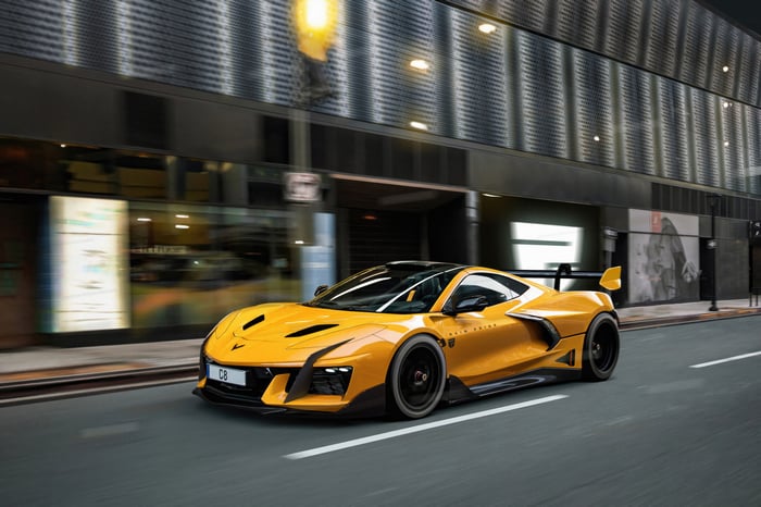 Yellow Corvette C8 driving on city street