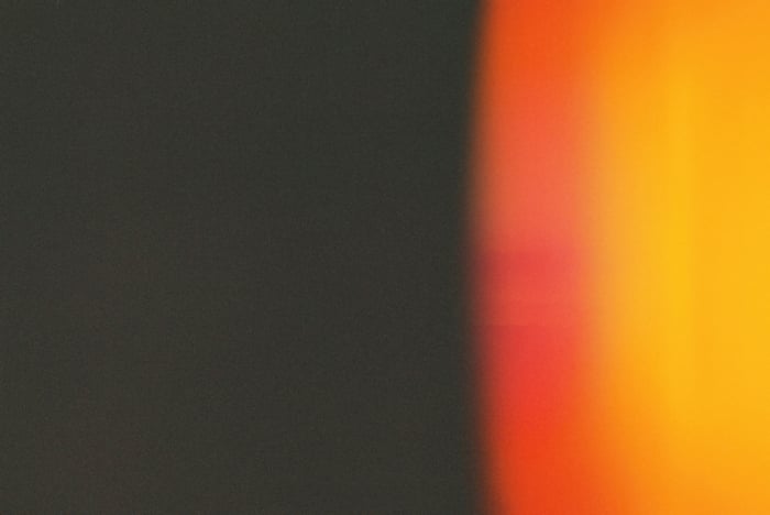 Abstract orange and black gradient with grain