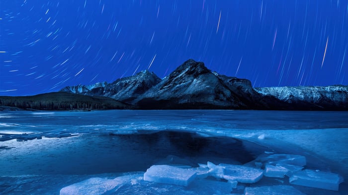 Star trails over frozen Lake Minnewanka, Alberta, Canada