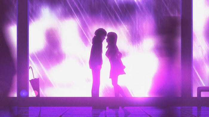 Couple silhouetted against purple rain