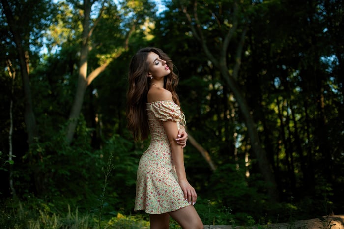 Girl in a floral dress in nature