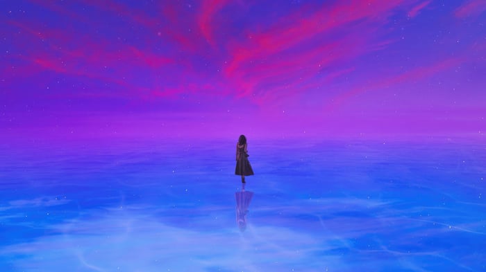 A person stands alone in a colorful world