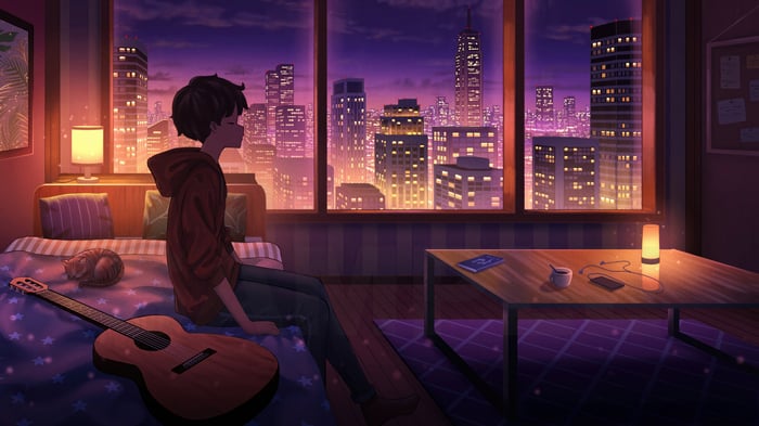 Boy in room overlooking city at night