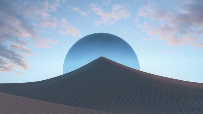 Surreal Desert Landscape with Giant Blue Sphere