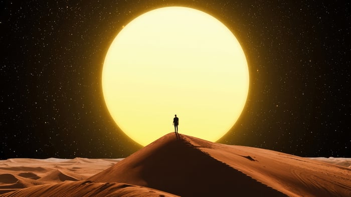 Man on Dune Facing Giant Sun