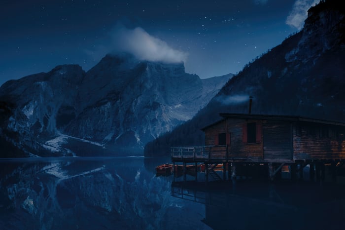 Wooden cabin on Pragser Wildsee lake at night