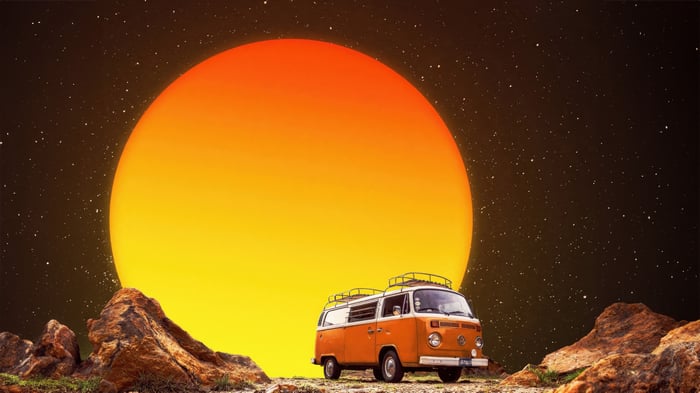 Orange Van parked in front of a giant sun