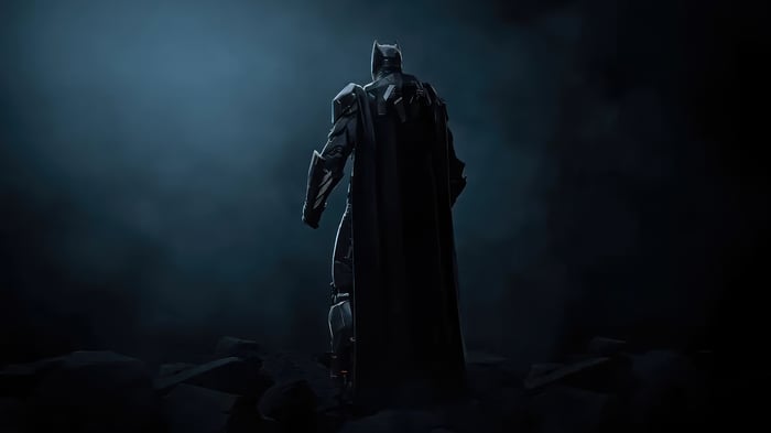 Batman standing in a dark, smoky environment