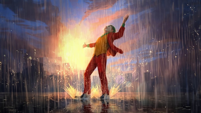 The Joker dancing in the rain in a city