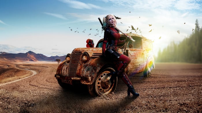 Female Deadpool and Deadpool in a rusty car