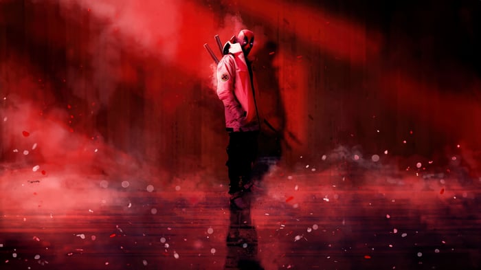 Deadpool standing in red smoke