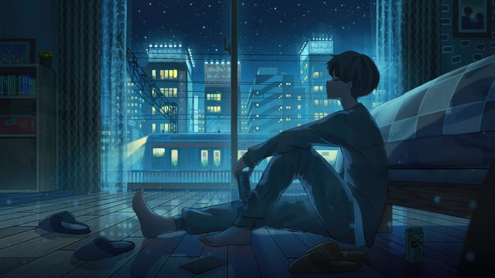 Person sitting by the window at night