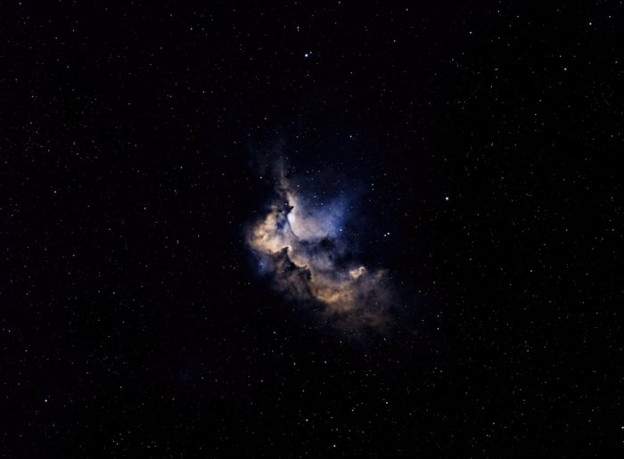 A colorful nebula surrounded by stars in deep space