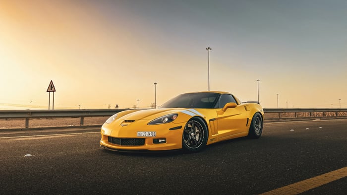 Yellow Corvette on a Road at Sunset