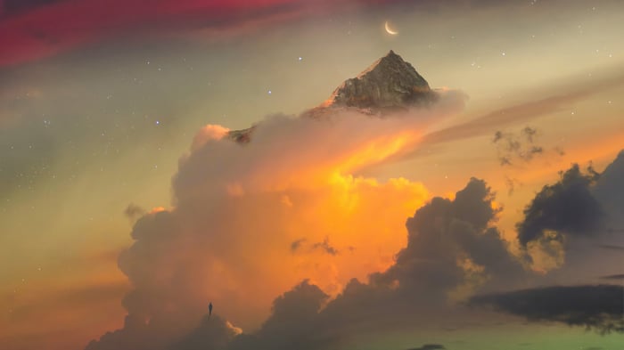 Mountain peak above clouds with crescent moon and stars