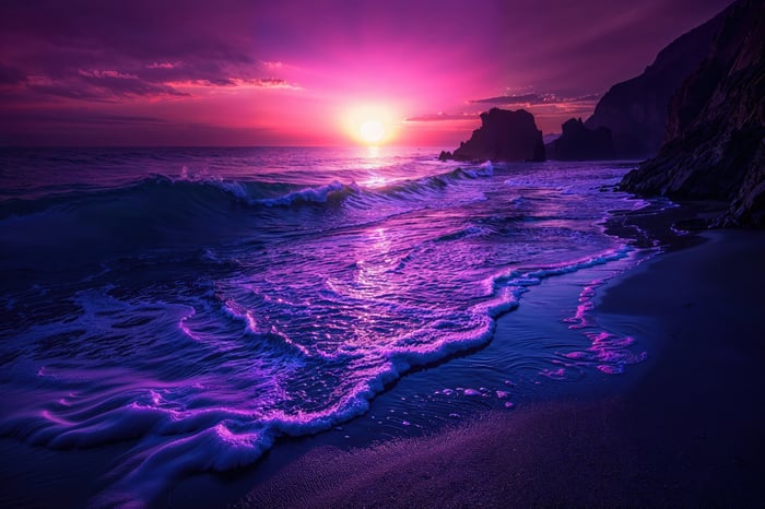 Purple Sunset Over Ocean Waves and Beach