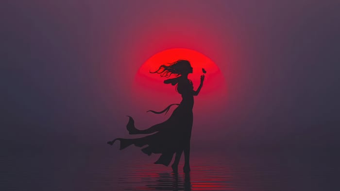 Silhouette of a woman with a butterfly against a red sun