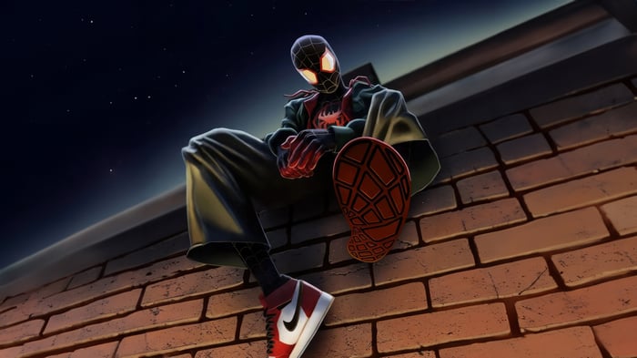 Spider-Man sitting on a brick ledge at night