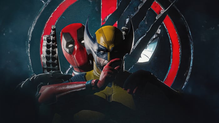 Wolverine and Deadpool in front of a broken symbol
