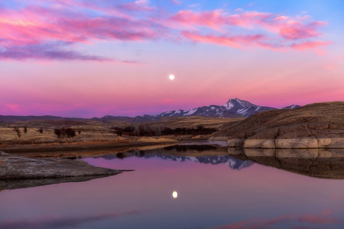 Full Moon Reflection Over Lake During Pink Sunset
