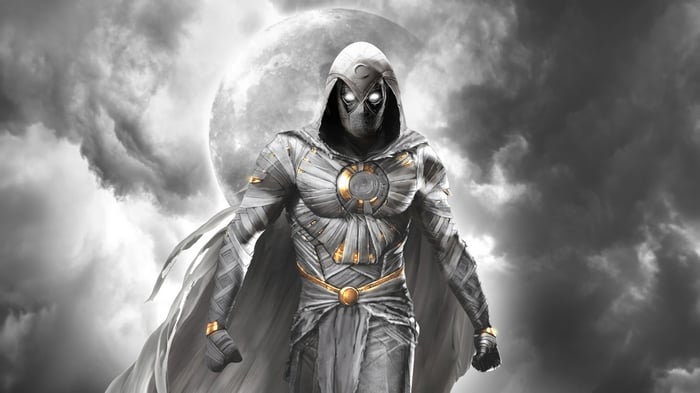 Moon Knight stands against a cloudy moonlit sky