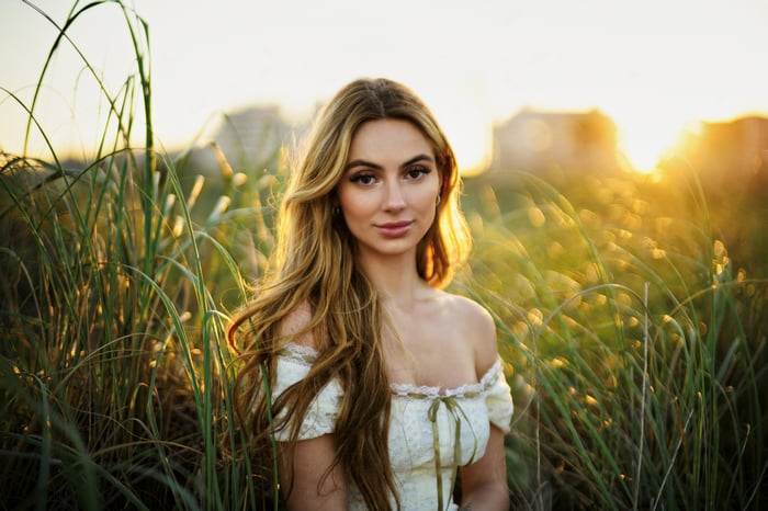 Girl in a field at sunset with bokeh