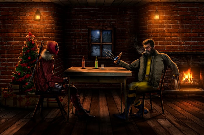 Deadpool and Wolverine drinking beer by a fireplace