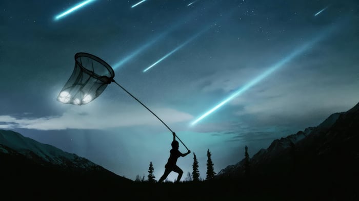 Child catching shooting stars with a net