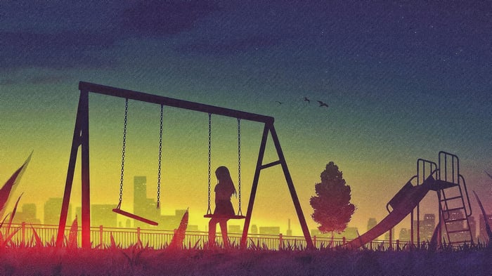 Girl on a swing in a park at sunset