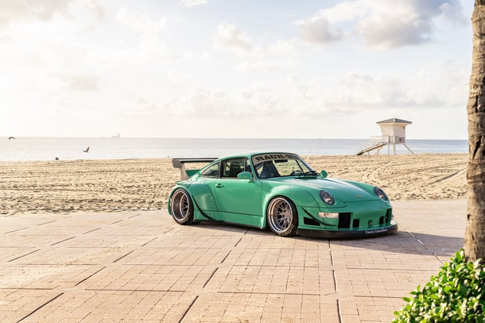 Green Porsche 993 RWB on a Beach Boardwalk
