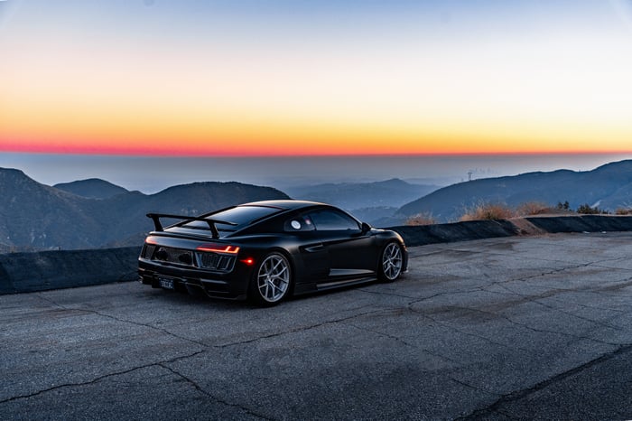 Black Audi R8 V10 on a mountain road at sunset