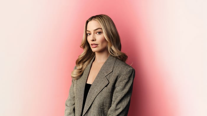 Margot Robbie in a gray blazer
